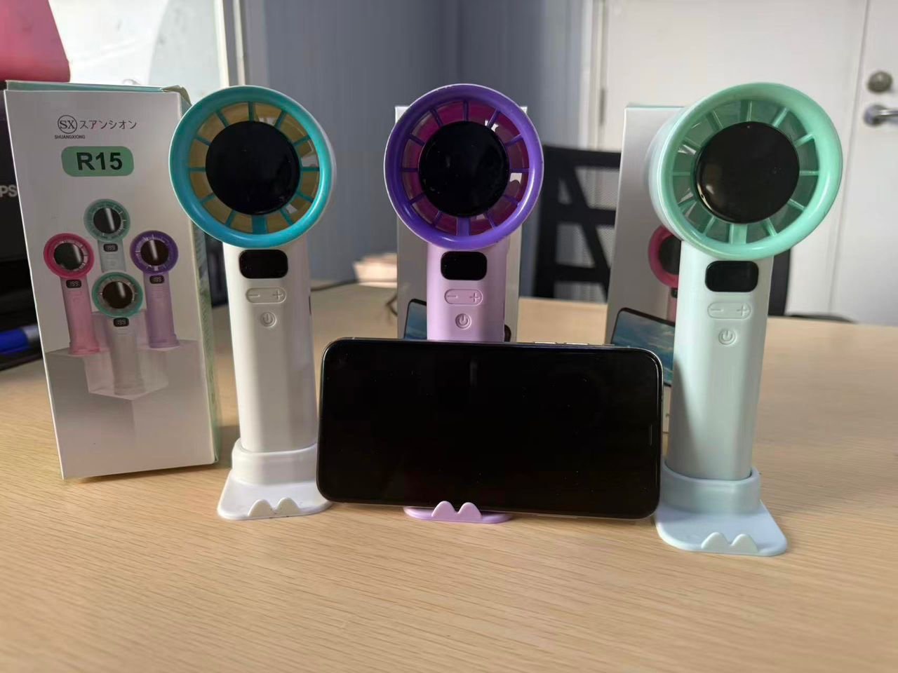 11d5aa1c-089b-46aa-a6c7-fc1a83418cb8 100-SPEED COOLING DIGITAL DISPLAY RECHARGEABLE HANDHELD FAN WITH PHONE HOLDER - Image 1